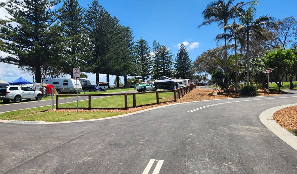 View of campsites and the access road at Trial Bay Gaol campground. Credit: Brandan Argent © DCCEEW