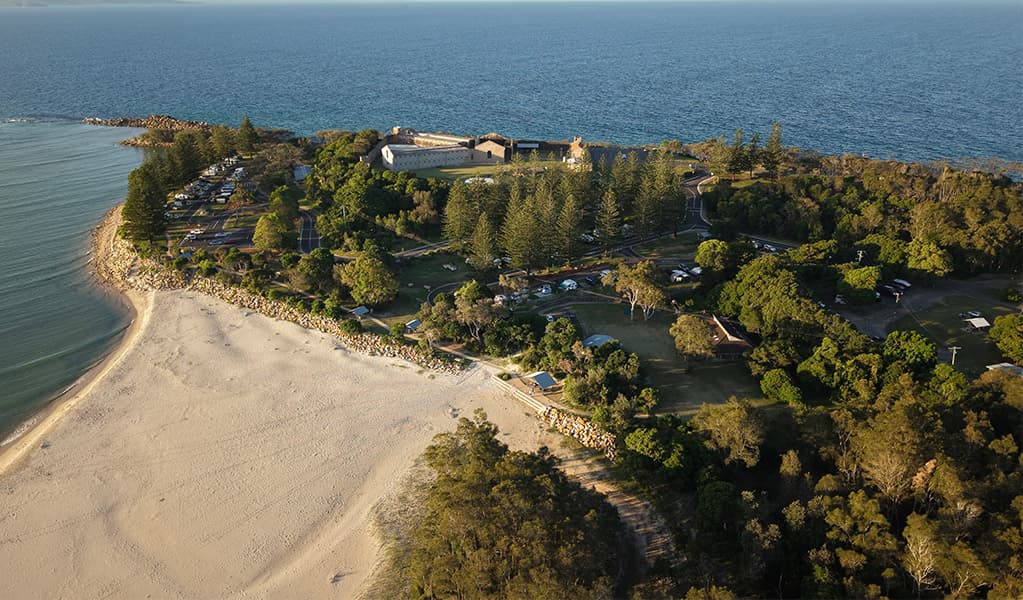 Aerial view of Trial Bay Gaol campground and Front Beach. Credit: Glen Ellis © DCCEEW