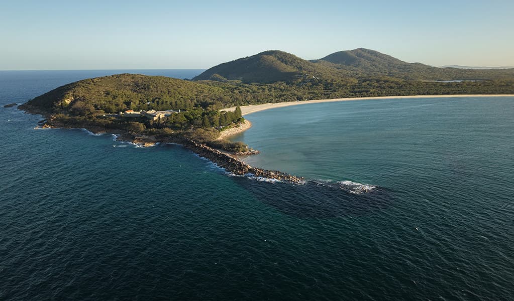 Aerial view of the headland and ocean at Trial Bay in Arakoon National Park. Credit: Glen Ellis © DCCEEW