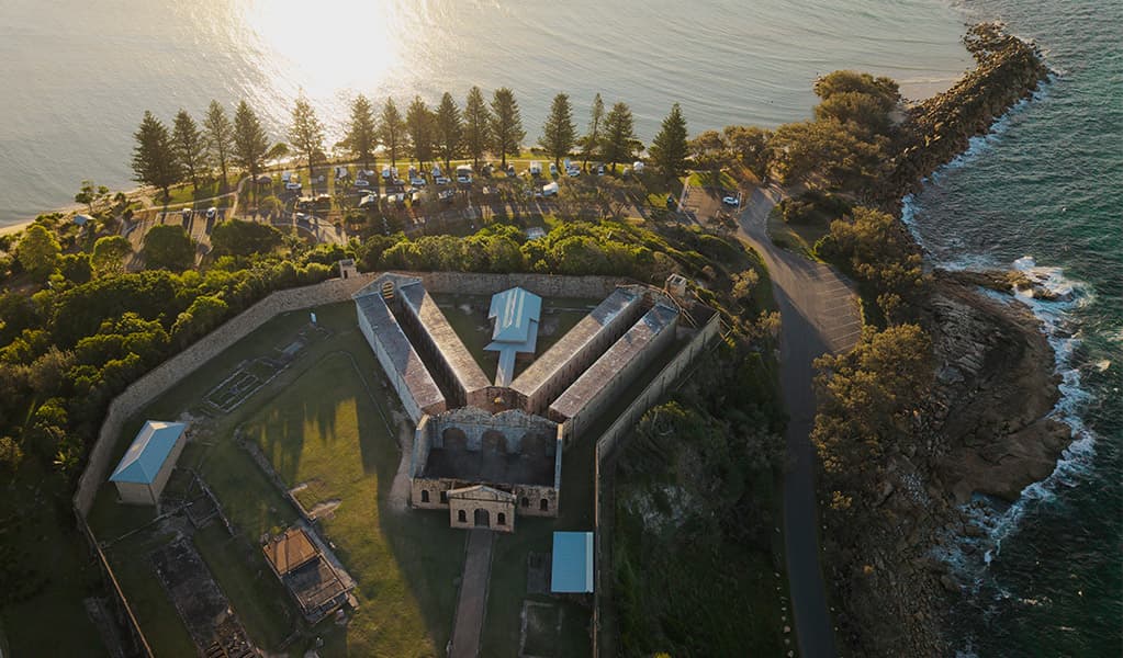 Aerial view of Trial Bay Gaol and the waterfront campsites. Credit: Glen Ellis © DCCEEW