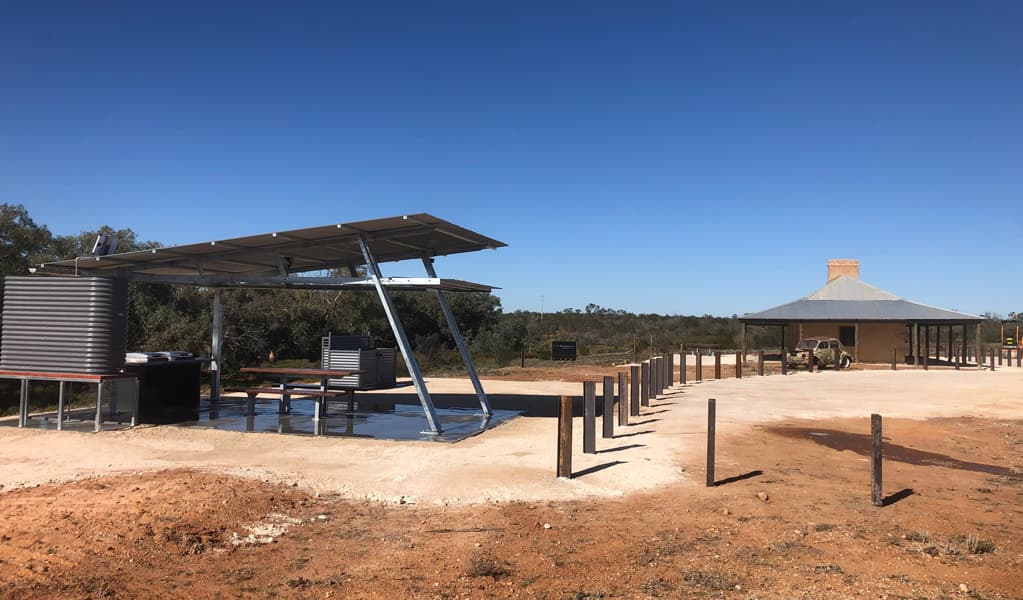 Picnic tables and barbecue under a shelter at Teilta campground and picnic area. Photo © DPE
