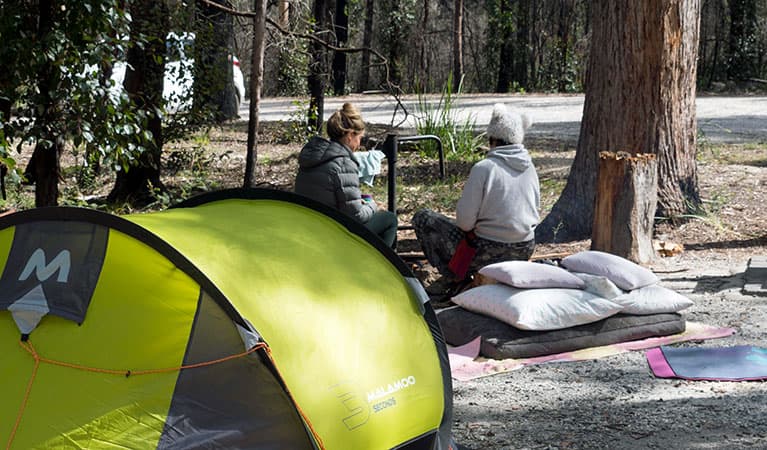 2 campers beside their tent at Bald Rock campground and picnic area in Bald Rock National Park. Photo: Leah Pippos © DPIE