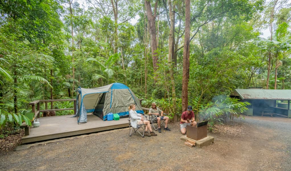 3 campers relaxing at their tent platform at Sheepstation Creek campground. Photo credit: John Spencer © DPE