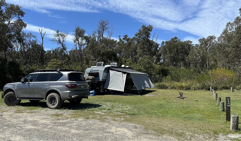 A tent setup next to vehicle at Crowdy Gap campground. Credit: © DCCEEW