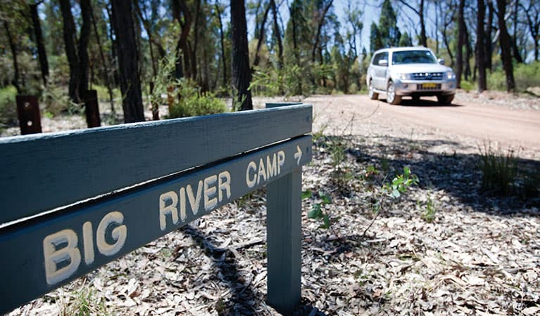 A sign towards Big River campground with a car in the background in Goulburn River National Park. Photo: Nick Cubbin © DPIE