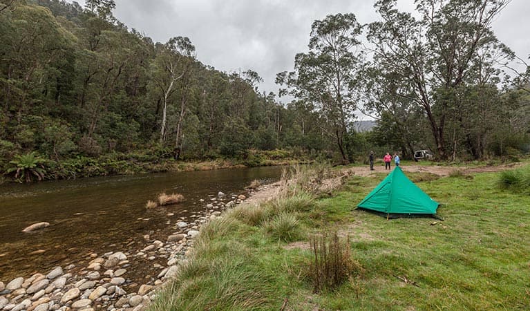 A green tent beside the Swampy Plain River at Old Geehi campground, Kosciuszko National Park. Photo: Murray Vanderveer/OEH