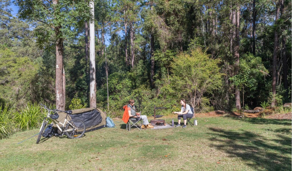 2 campers outside their tent, Cutters Camp campground. Credit: John Spencer © DPE