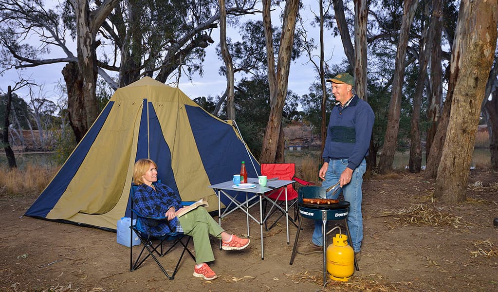 Campers barbecuing outside their tent at Millewa campgrounds in Murray Valley Regional Park. Photo: Gavin Hansford © OEH