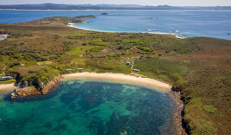 An aerial view of Broughton Island campground and nearby beach in Myall Lakes National Park. Photo: John Spencer © DPIE