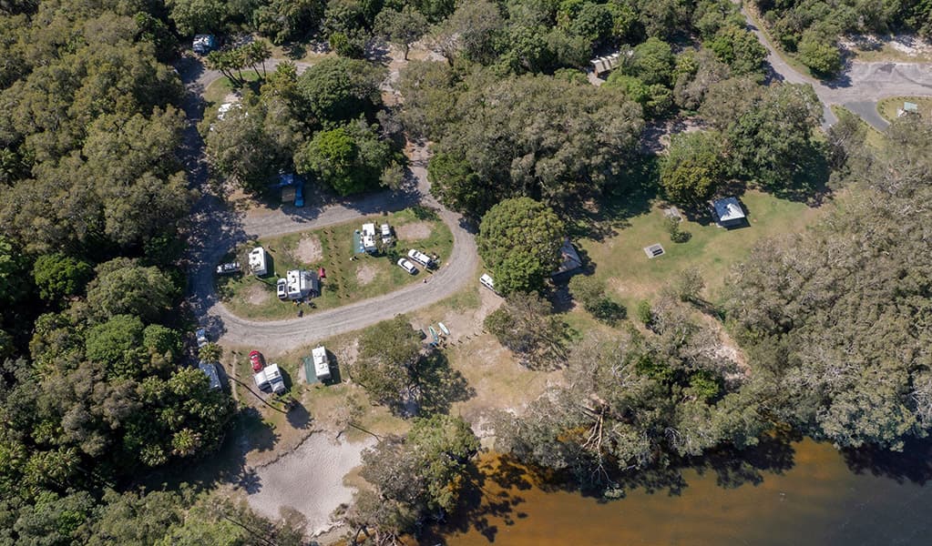Aerial view of Mungo Brush campground and nearby Myall Lake in Myall Lakes National Park. Credit: John Spencer/DCCEEW © DCCEEW