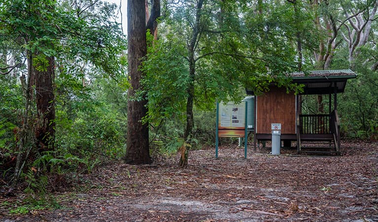 View of toilet block set in a sandy clearing surrounded by trees. Photo: John Spencer © DPIE