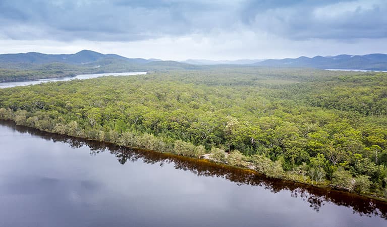 Aerial view of remote Two Mile Sands campground with surrounding bushland and waterways in Myall Lakes National Park. Photo: John Spencer © DPIE