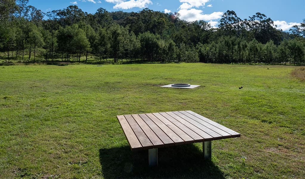 Seating area at Blue Gums campground in Yengo National Park: Credit: Allan Chawner © DCCEEW