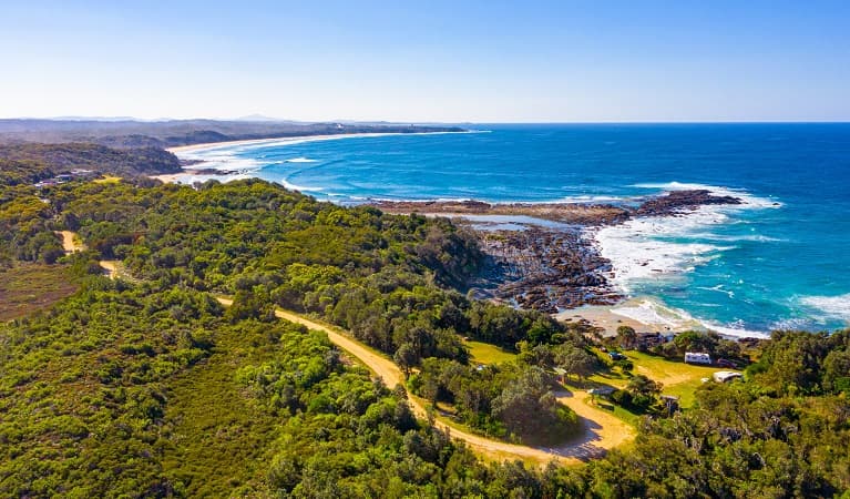 An aerial view of Boorkoom campground with ocean in the background in Yuraygir National Park. Photo: Jessica Robertson © DPIE